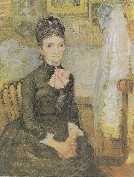 Woman sitting next to a cradle